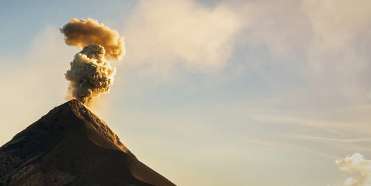 Volcan de Fuego erupting with a golden ash plume above Antigua, Guatemala