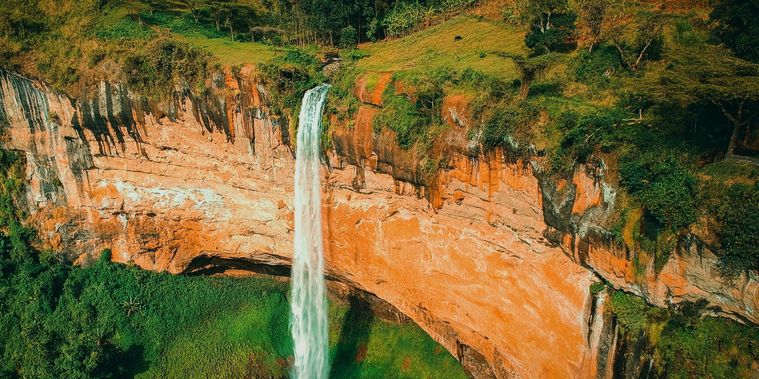 Sipi Falls plunging over an orange cliff in the Mount Elgon coffee highlands of Uganda